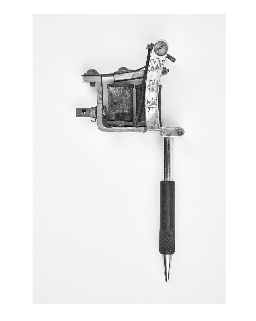 A print in black and white of a Spaulding and Rogers tattoo machine.