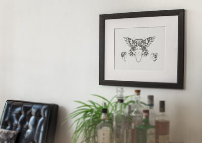 Butterfly lady tattoo flash hanging on wall